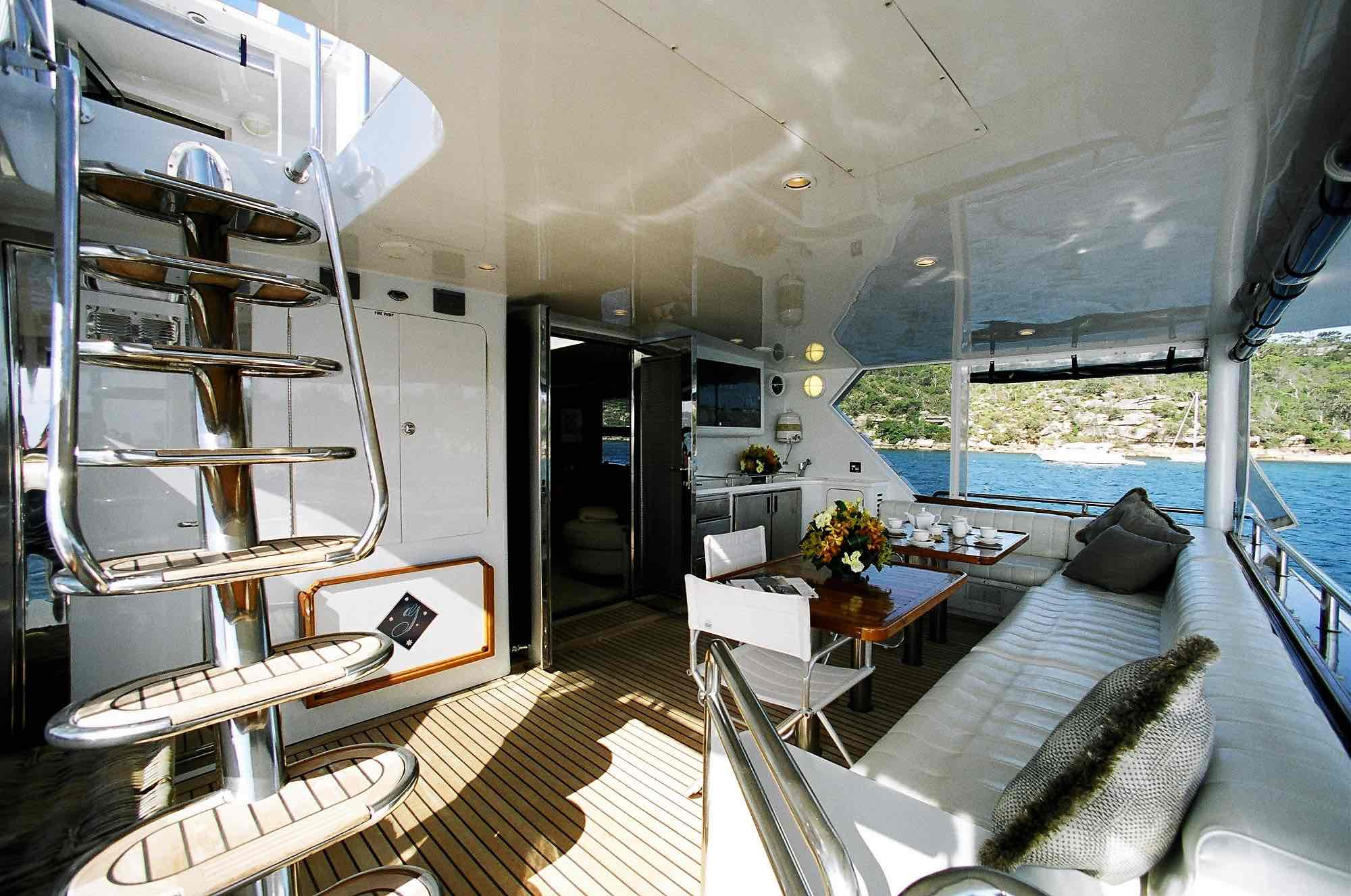 Aft deck lounge and stairs on Galaxy I luxury boat hire
