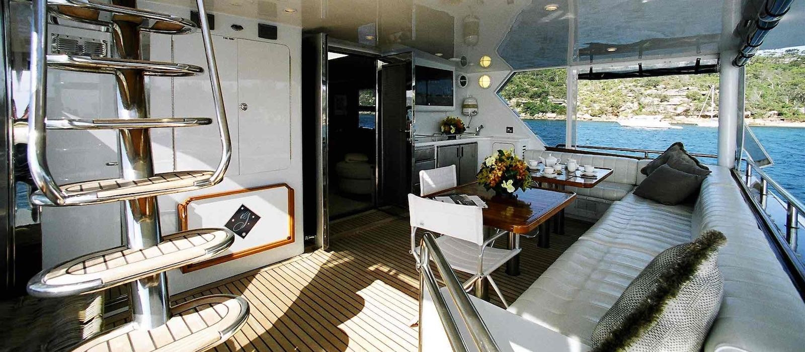 Aft deck lounge and dining on Galaxy I luxury boat hire Whitsundays