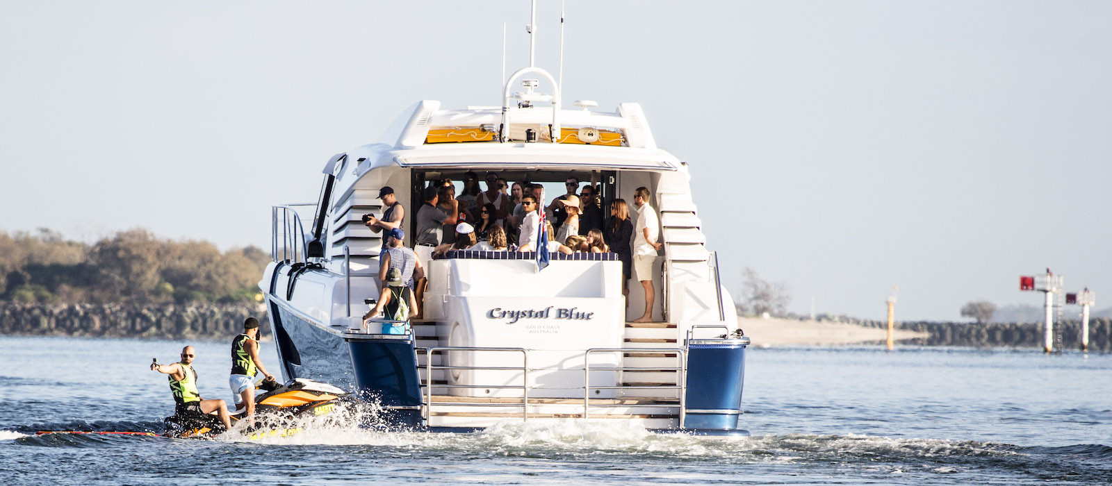 Rear view and celebrations on aft deck of Crystal Blue luxury boat hire