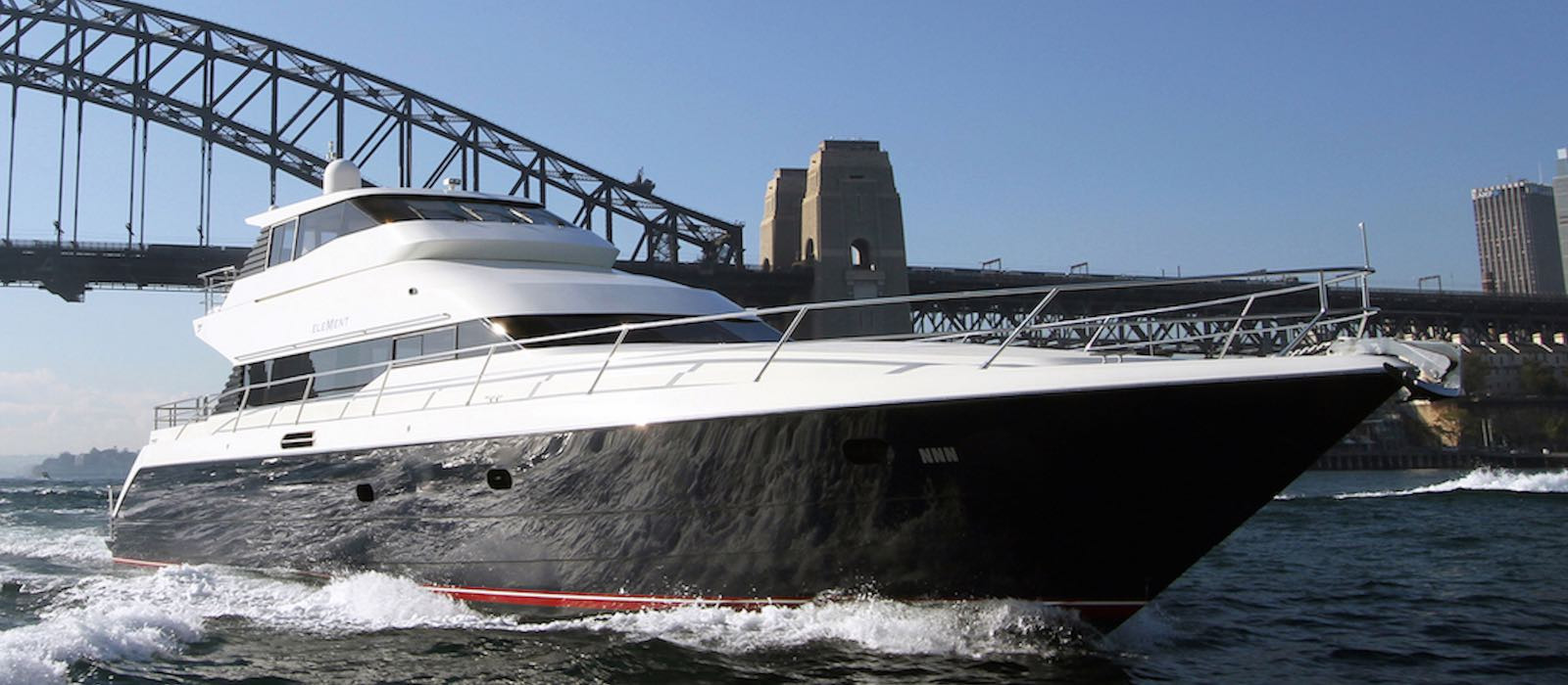 Luxury boat hire Element passing under Harbour Bridge