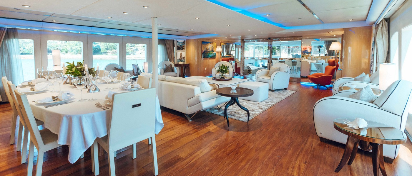 Main deck dining and lounge on Tango Luxury boat hire 
