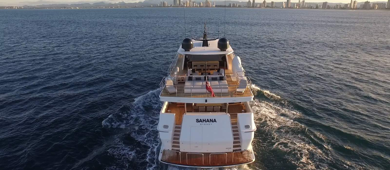 Aerial stern view of Sahana superyacht hire heading towards Gold Coast